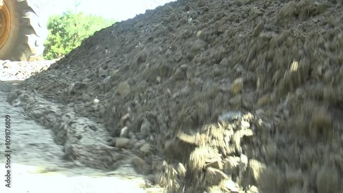 Repair of the road in the middle of the forest with the help of a grader