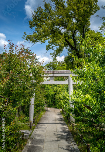 A traditional stone Japanese Torii Gate at the entrance to a shrine in Kyoto