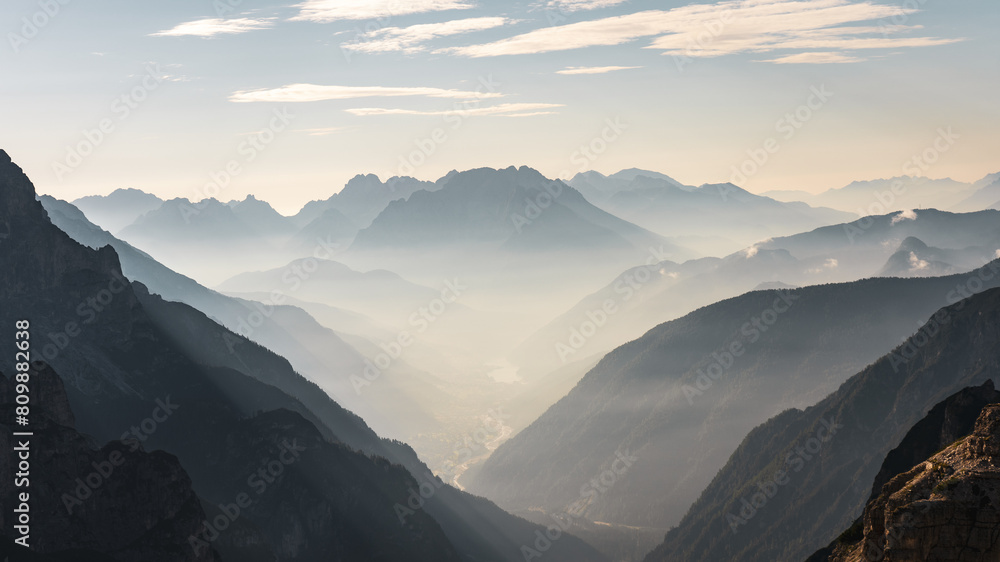 Mountainous valley with fog at dawn