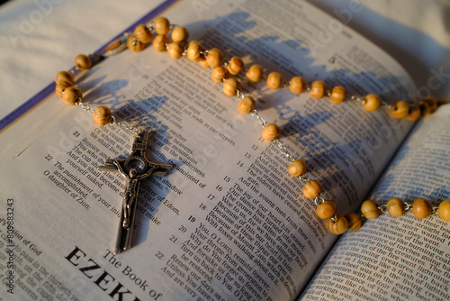 Rosary on an open bible. The book of Ezekiel.