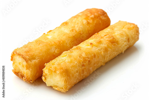 two fried bread sticks on a white surface