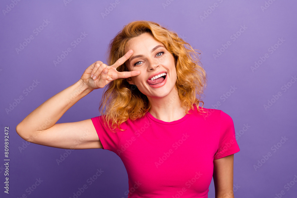 Photo of charming funky woman stylish clothes hand showing v-sign good mood isolated on purple color background