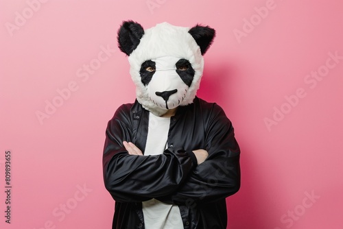Man dressed as a panda with pastel pink background