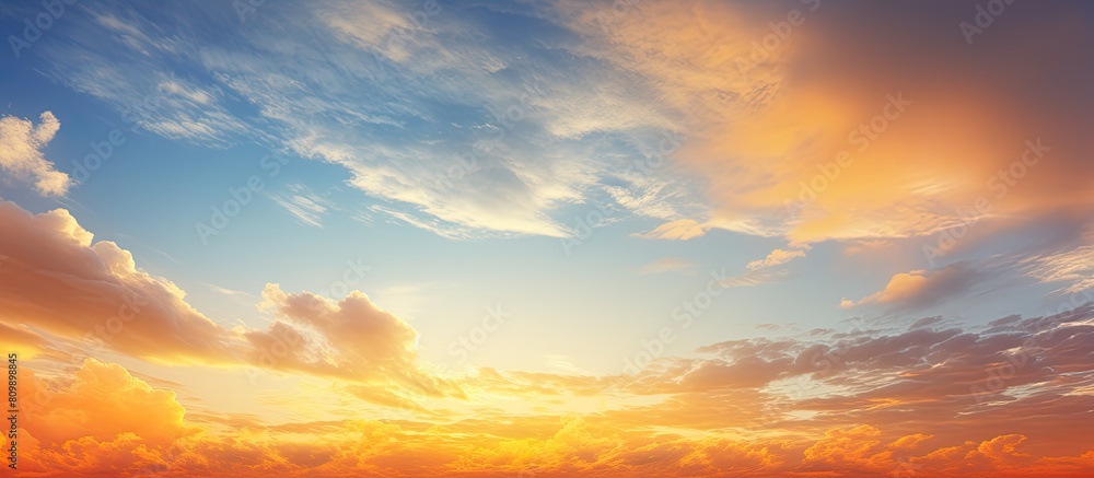 A stunning sky with vibrant colors during sunset or sunrise featuring an orange hue blending with the clouds creating a picturesque background suitable for a copy space image