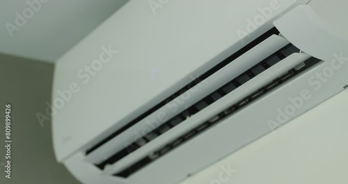 Air conditioner operation, flow louvers move up and down, distributing the air flow