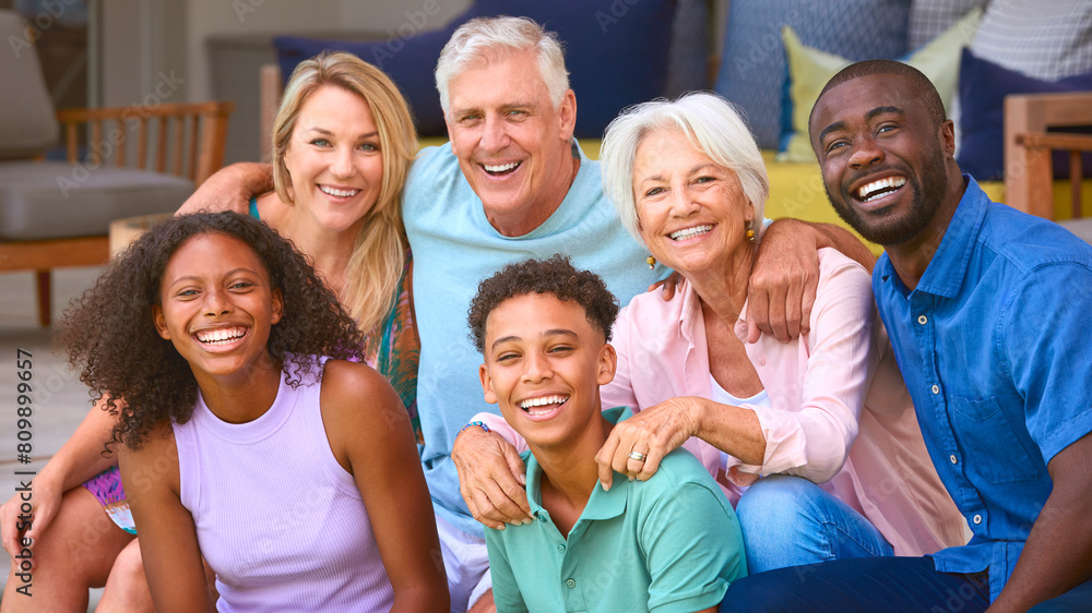 Portrait Of Three Generation Family Laughing And Smiling Sitting Outdoors At Home On Deck Together Portrait Of Three Generation Family Laughing And Smiling Sitting Outdoors At Home On Deck Together