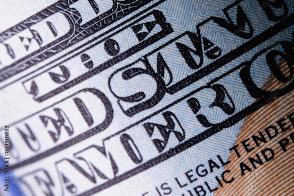 Macro image with description: THE UNITED STATE OF AMERICA on one hundred US Dollar bill. High resolution photo. Macro image with description: THE UNITED STATE OF AMERICA on one hundred US Dollar bill. High resolution photo.