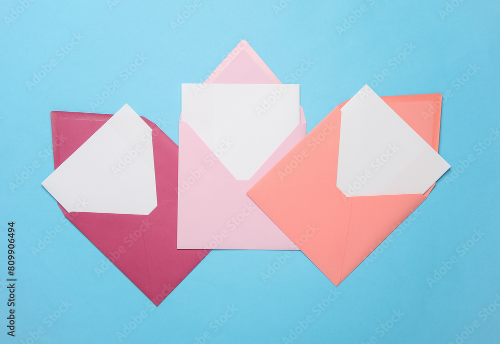 Pink envelope with white blank letter and marker on a blue background. Creative layout Pink envelope with white blank letter and marker on a blue background. Creative layout