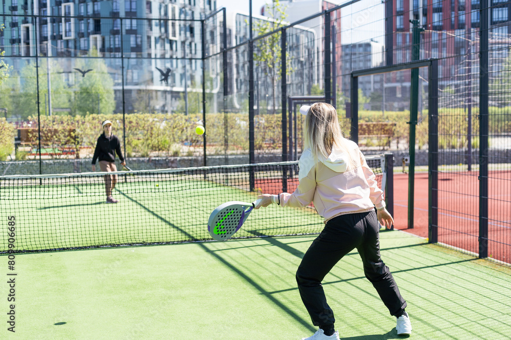 Obraz premium mother and daughter playing padel outdoor