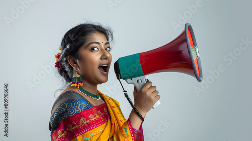 Indian woman in a sari holding a megaphone announces what she wants to say.  photo