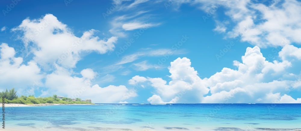 The scenic beauty of Okinawa is enhanced by the tranquil turquoise sea the clear blue sky and the presence of fluffy white clouds during the summer creating a perfect copy space image The scenic beauty of Okinawa is enhanced by the tranquil turquoise sea the clear blue sky and the presence of fluffy white clouds during the summer creating a perfect copy space image
