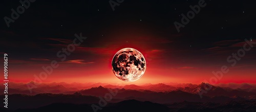 During the total lunar eclipse the moon assumes a captivating red hue against the night sky creating a mesmerizing astronomical background with ample copy space photo