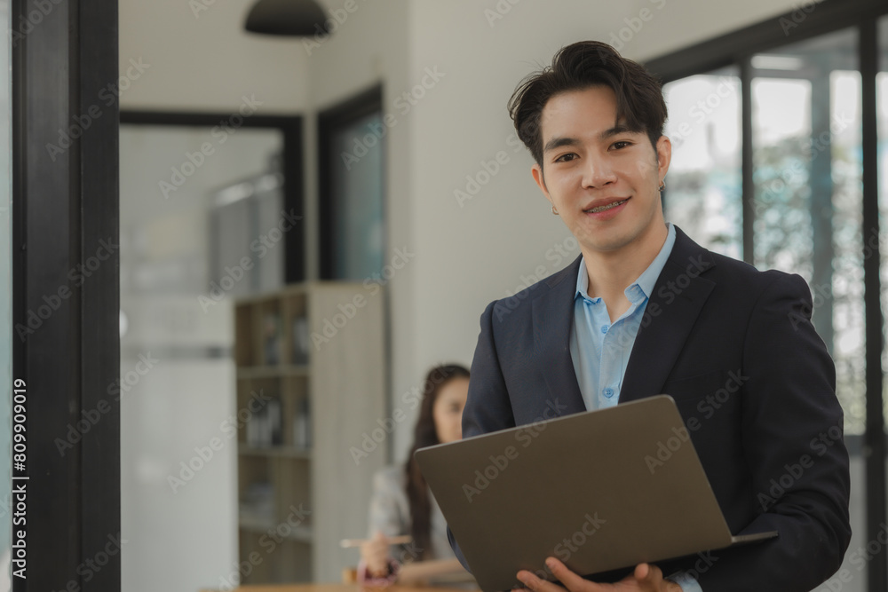 an employee is working in modern office and another coworkers are in the same room, working atmosphere in the office, businesspeople, work happily in the company