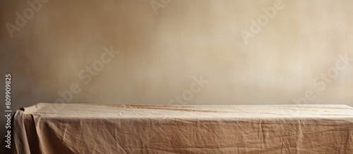 A table with a piece of rough textured fabric creating the perfect backdrop for a copy space image
