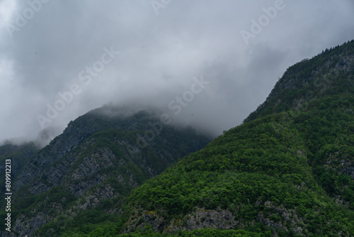 Rain clouds over the tops of mountains with green slopes. Beauty of nature concept background 