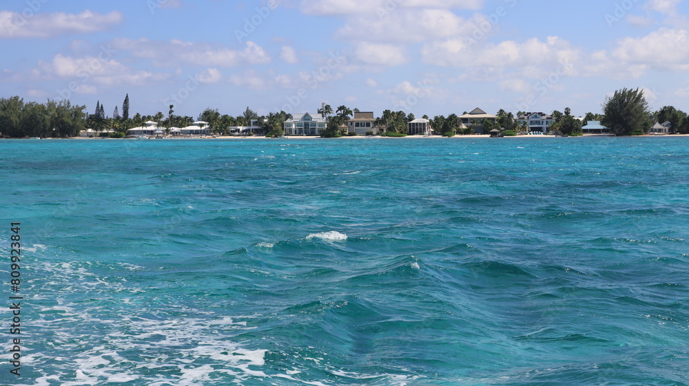 grand cayman, cayman islands from the caribbean sea tropical island vibes  pristine blue turquoise sea water of the caribbean Atlantic ocean waves trees green