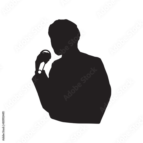 マイクを持って語るあるいは歌を歌う男性のシルエットイラスト　黒