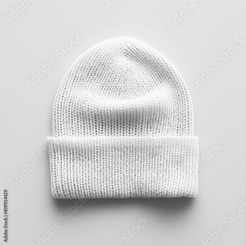 White Beanie Mockup with Detachable Label. Winter Fashion Cap Isolated on Wool Texture Background