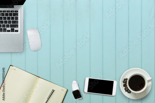Blank screen laptop, smartphone, smart watch, wiress mouse and a cup of coffee on sweet color table