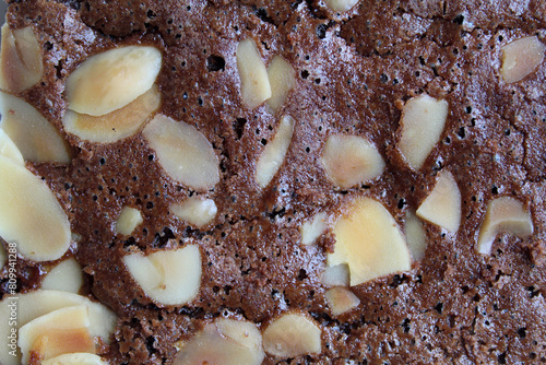 Close up texture of brownies cake upper skin with almond topping photo