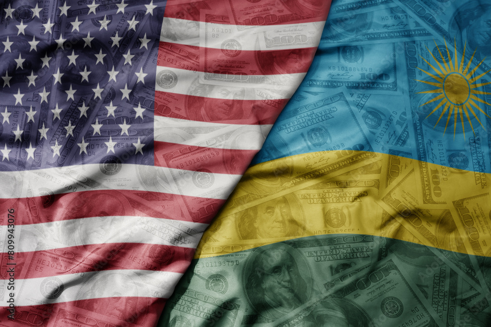 Obraz premium big waving colorful flag of united states of america and national flag of rwanda on the dollar money background. finance concept .