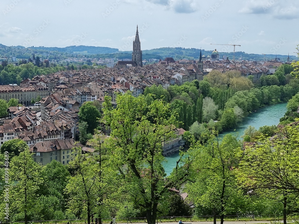 Bern, Switzerland. View on the city center from a mountain, beautiful Aara, green trees, tradicional buildings with red roofs