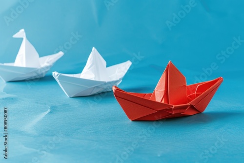 Row of origami boats on blue surface  ideal for nautical themed designs