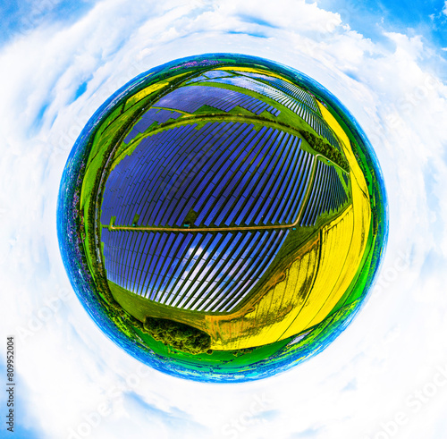 Aerial 360 Tiny Planet shot of large solar farm surrounded by farmers fields photo