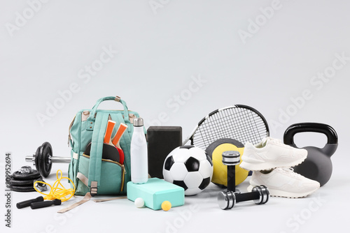 Many different sports equipment on light grey background © New Africa