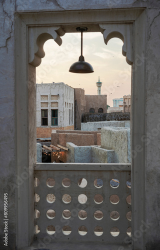 Arabic Architecture - a city scape rooftop skyline through a window frame in Al Seef Khor Dubai-01 photo