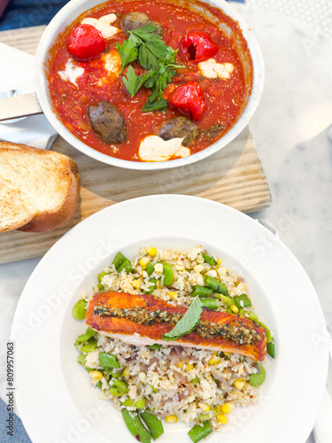shakshuka with falafel and risotto with salmon, healthy lunch top view