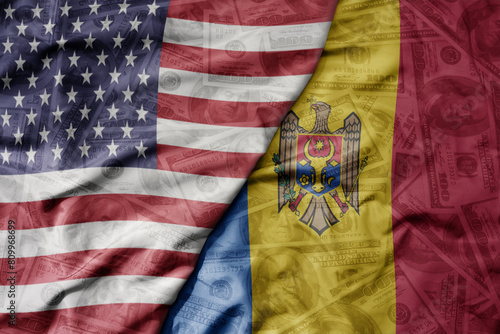 big waving colorful flag of united states of america and national flag of moldova on the dollar money background. finance concept .