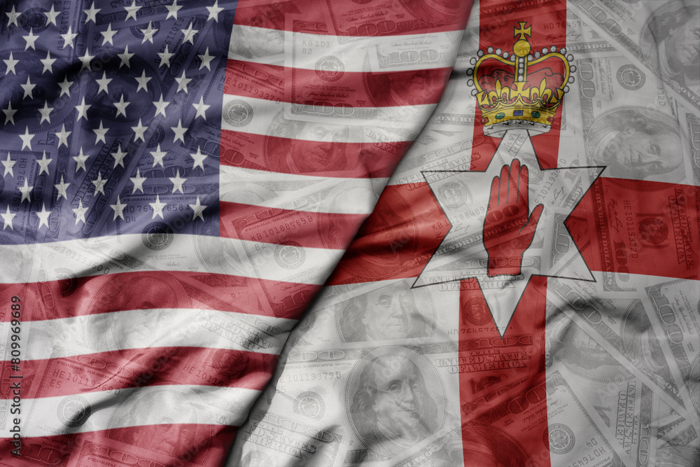 Fototapeta premium big waving colorful flag of united states of america and national flag of northern ireland on the dollar money background. finance concept .