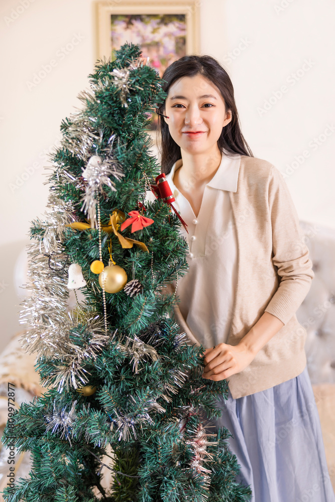 woman decorating christmas tree woman decorating christmas tree