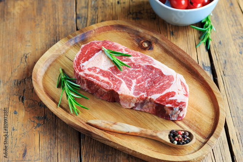rohes Ribeye Steak mit Gewürzen photo