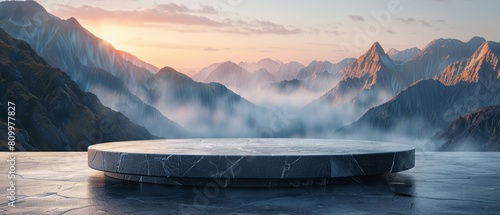 Product showcase on a stone tabletop, enhanced by a picturesque background of mountains and mist at the break of dawn photo