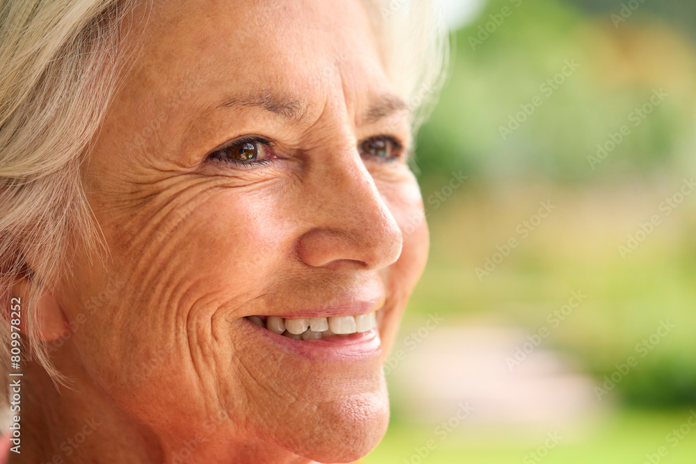 Close Up Portrait Of Senior Woman At Home With Garden In Background Close Up Portrait Of Senior Woman At Home With Garden In Background