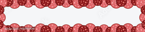 Slices of salami sausage border. Frame of Salame Meat delicatessen gastronomic product. National Salami Day