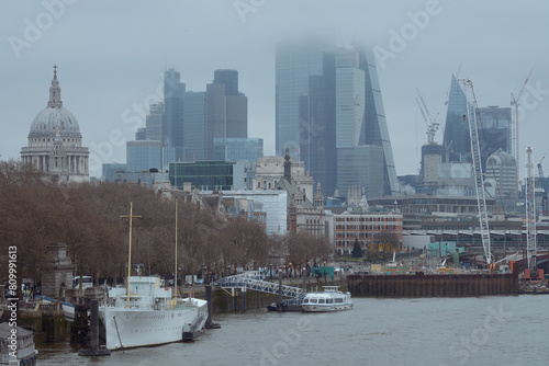 Waterfront on the north bank of the Thames against the backdrop of the skyscrapers of the City of London. United Kingdom