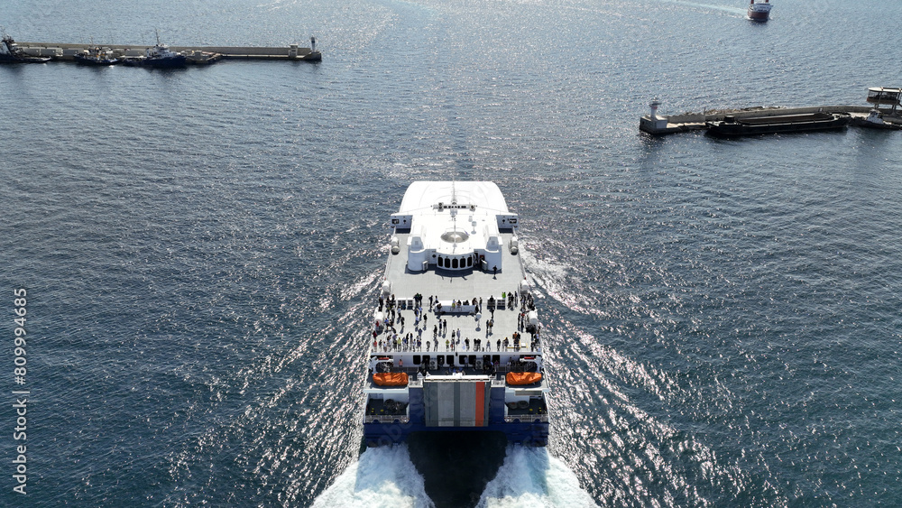Aerial drone photo of high speed Seajet passenger vessel leaving port of Piraeus to Aegean Cycladic island destination