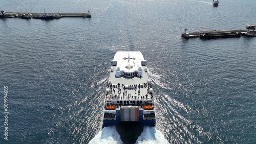 Obraz na płótnie Aerial drone photo of high speed Seajet passenger vessel leaving port of Piraeus to Aegean Cycladic island destination w salonie