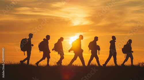 A group of people in silhouette confidently walking against a backdrop of a serene natural landscape,