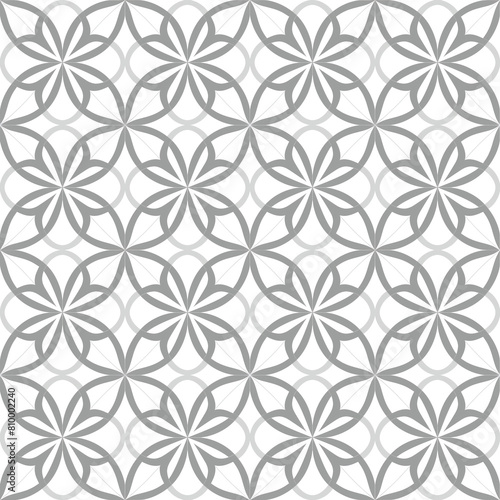 Seamless pattern with abstract geometric floral shapes in gray and white. The design is ideal for sophisticated decor and textiles, providing a modern yet timeless aesthetic