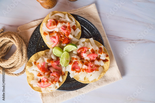 Cueritos tostadas with sauce and vegetables. photo