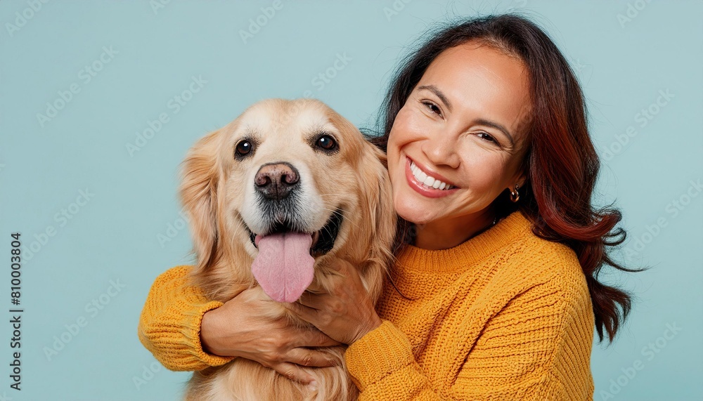 Happy woman with golden retriever on blue background