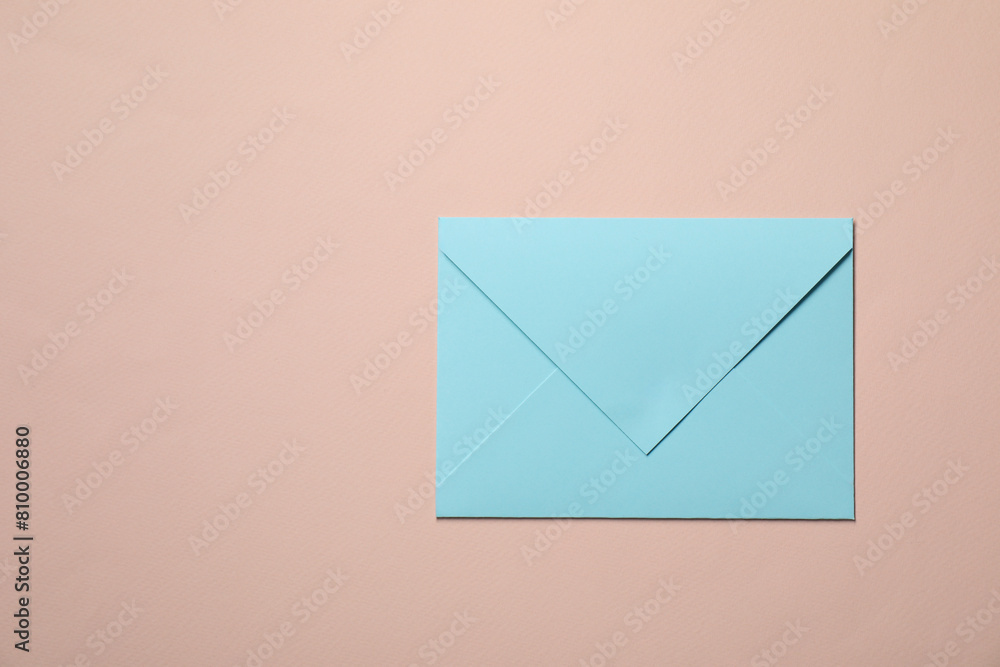 Letter envelope on beige background, top view. Space for text Letter envelope on beige background, top view. Space for text