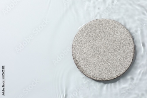 Presentation of product. Stone podium in water on white background, top view. Space for text