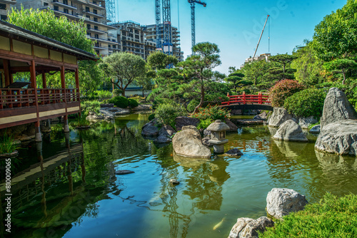 Amazing landscape  in Japanese garden of Monaco with pond , larhe rocks and  red pond