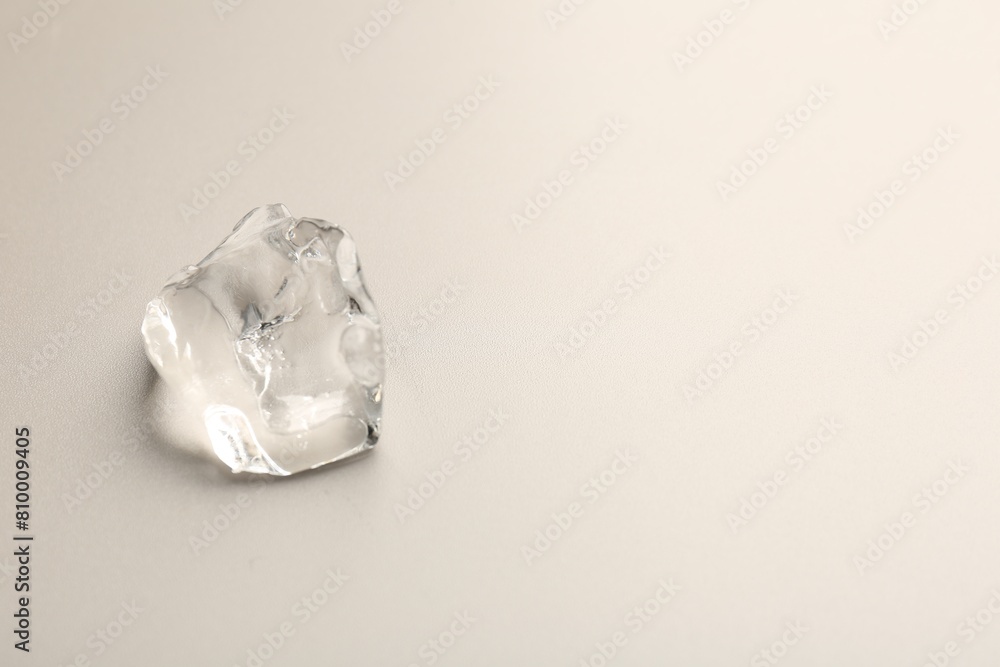Piece of crushed ice on grey background, top view. Space for text Piece of crushed ice on grey background, top view. Space for text