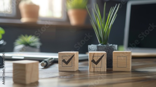 Wooden blocks with check marks building up on an office desk during a busy workday photo